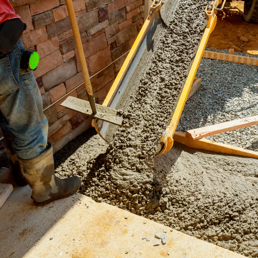 Construction worker pouring concrete